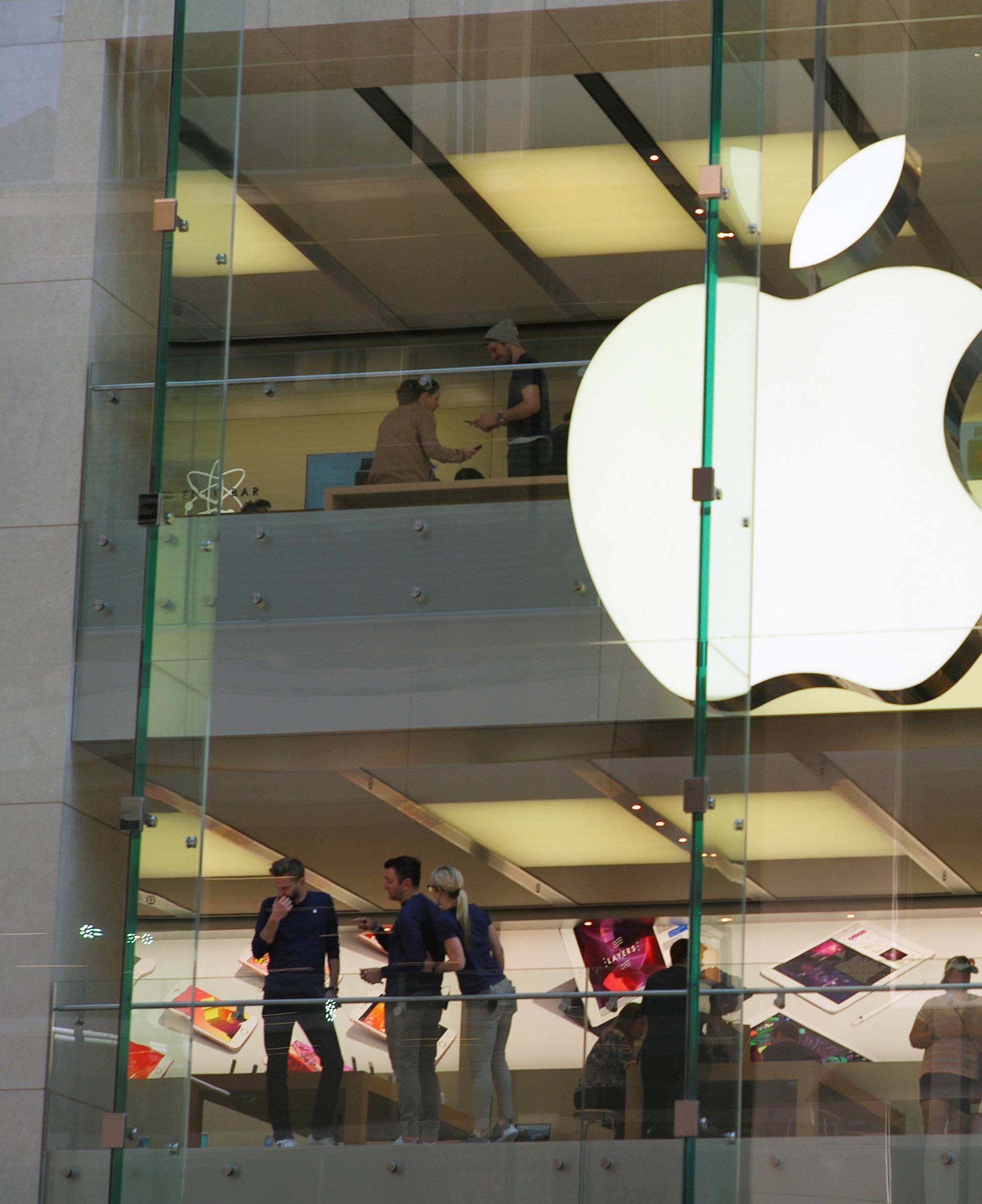 Customers and employees are shown through Apple's Australian flagship store in Sydney