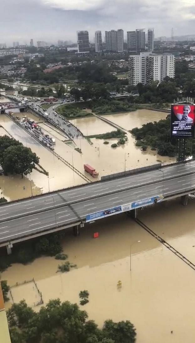 A view shows various vehicles stranded in the middle of flooded road, in Shah Alam