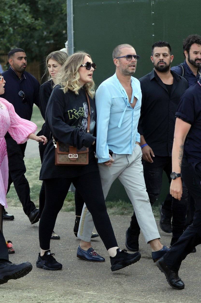 Adele holds hands with a male friend en route to watch Celine Dion in Hyde Park, London.