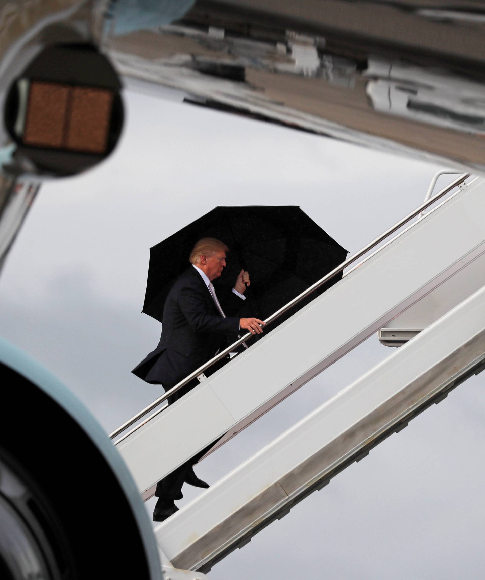 U.S. President Donald Trump boards Air Force One as he departs West Palm Beach, Florida