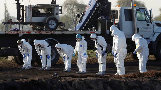 Forensic technicians work at the site where a fuel pipeline ruptured by suspected oil thieves exploded, in the municipality of Tlahuelilpan