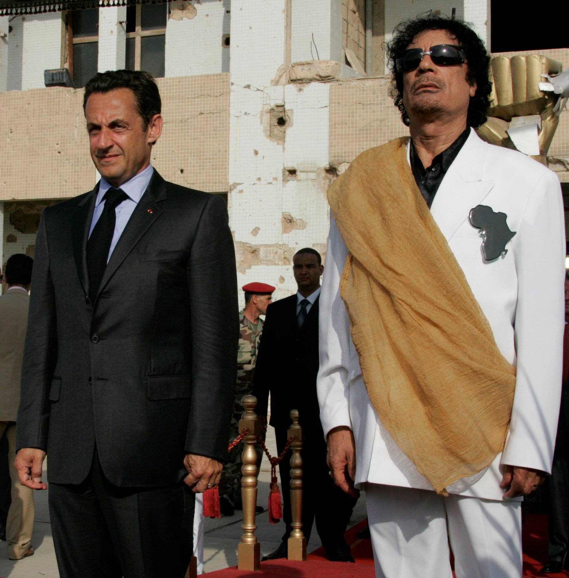 FILE PHOTO: Libya's President  Gaddafi and his counterpart from France Sarkozy listen to national anthems at Bab Azizia Palace in Tripoli