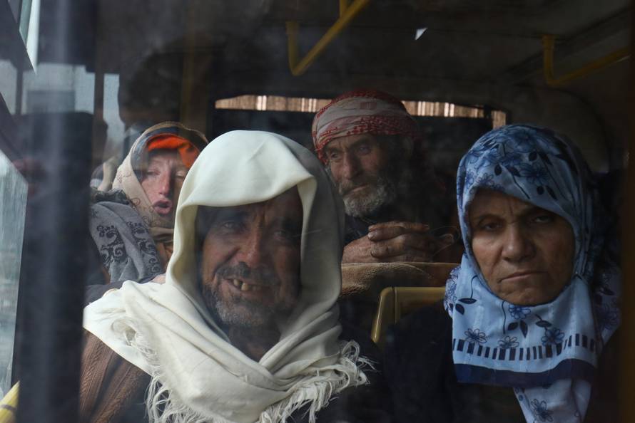 Evacuees from the Shi'ite Muslim villages of al-Foua and Kefraya ride a bus at insurgent-held al-Rashideen in Aleppo province