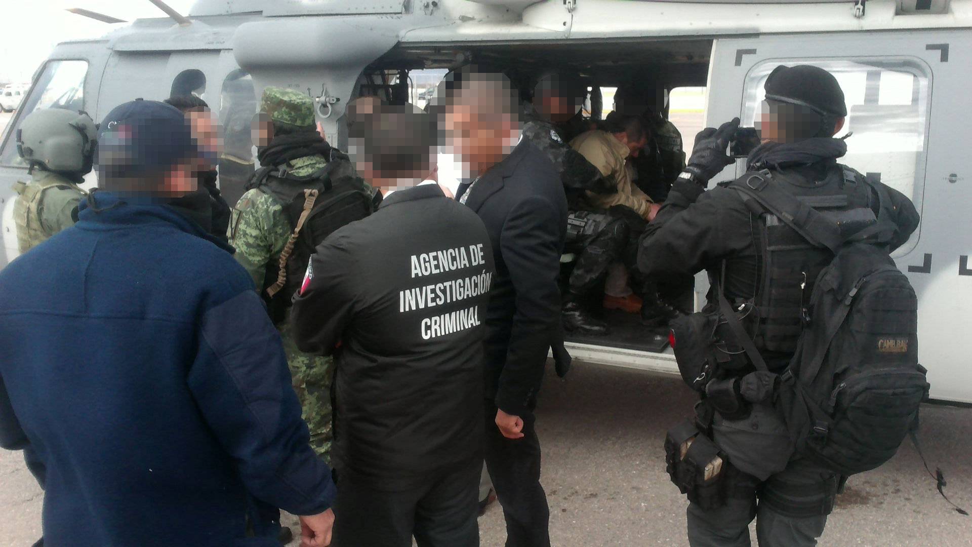 Mexico's top drug lord Joaquin "El Chapo" Guzman sits in a helicopter in Ciudad Juarez, Mexico, as he is extradited to New York
