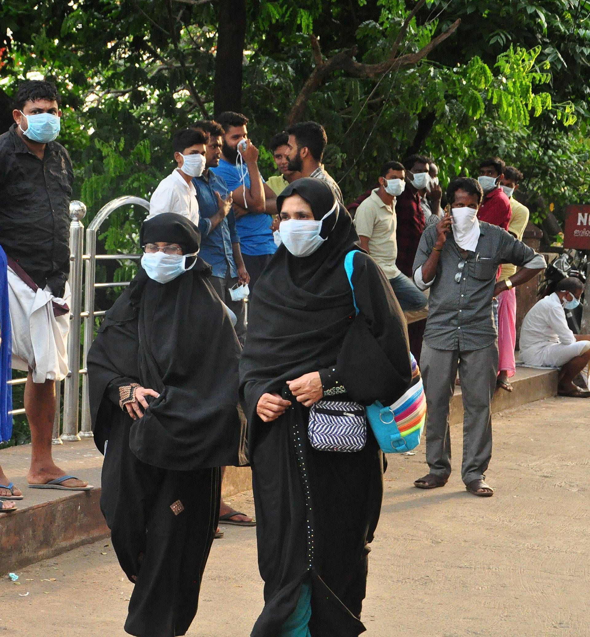 People wearing masks are seen at a hospital in Kozhikode