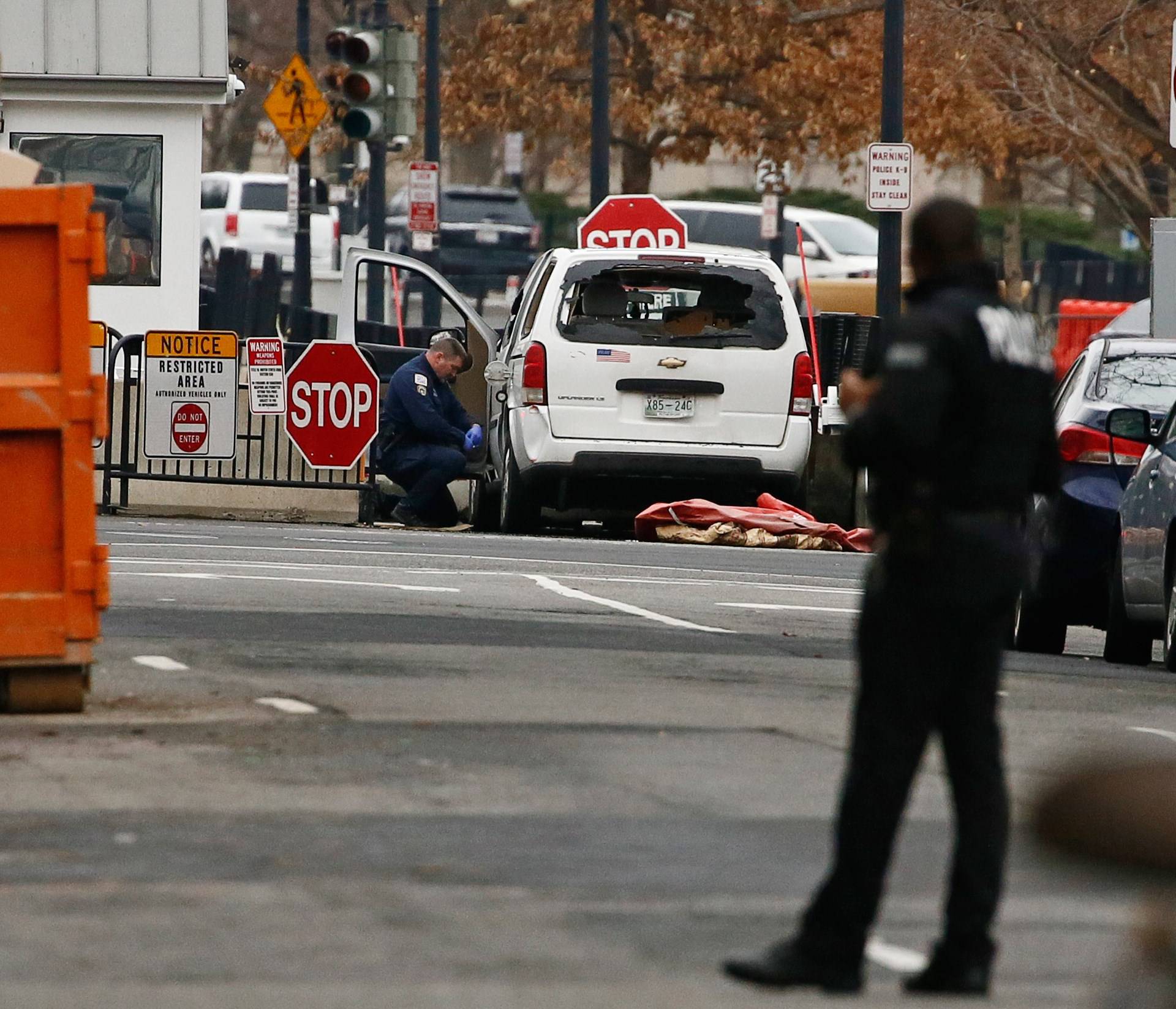 A passenger vehicle that struck a security barrier sits near the White House in Washington