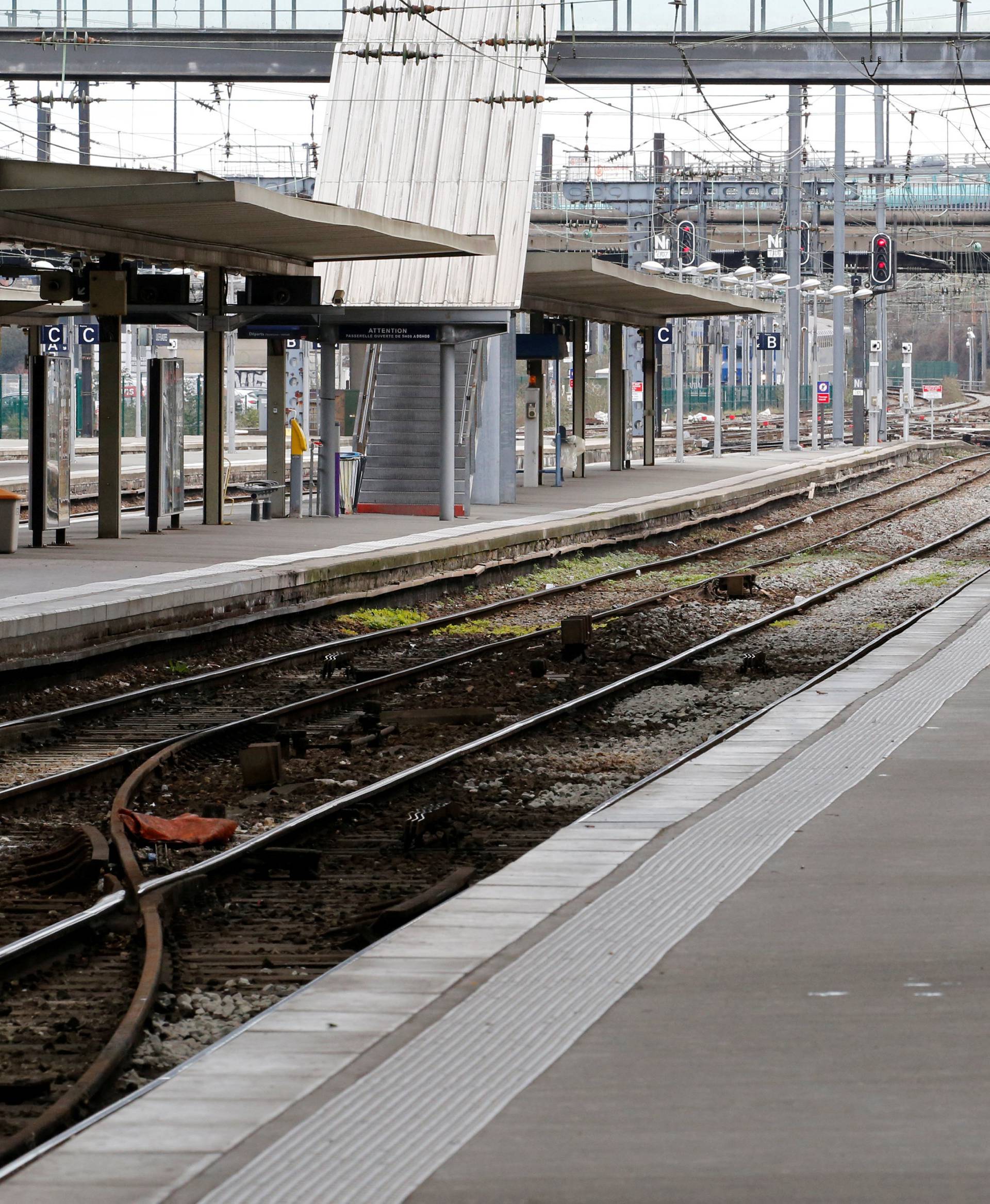 A man sits on a platform at the Gare Lille Flandres railway station a few hours before a nationwide strike by French SNCF railway workers, in Lille