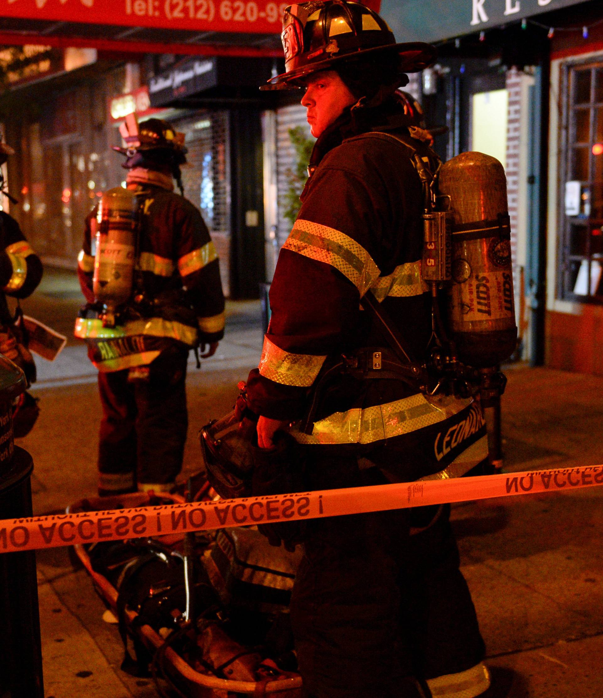 New York City firefighters stand near site of explosion in New York
