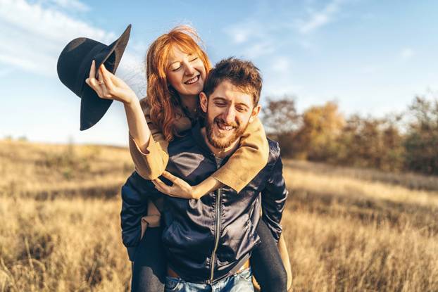 Pretty young romantic couple spend time together outdoor.