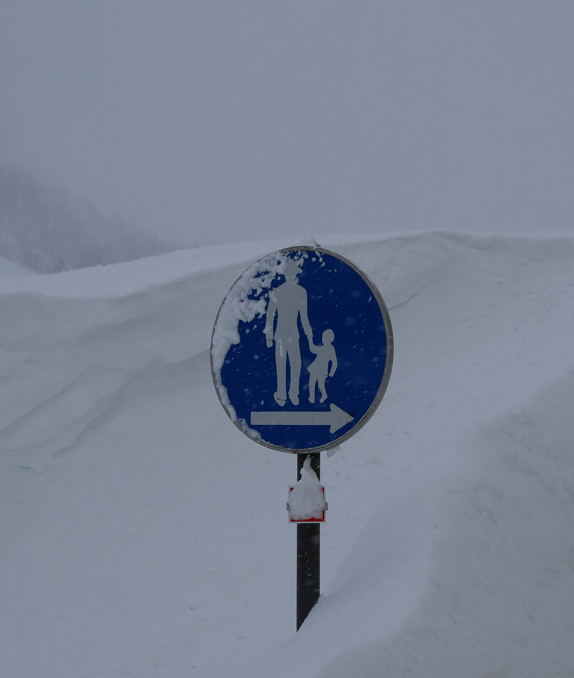 A sign is seen on a road after heavy snowfall in Obertauern