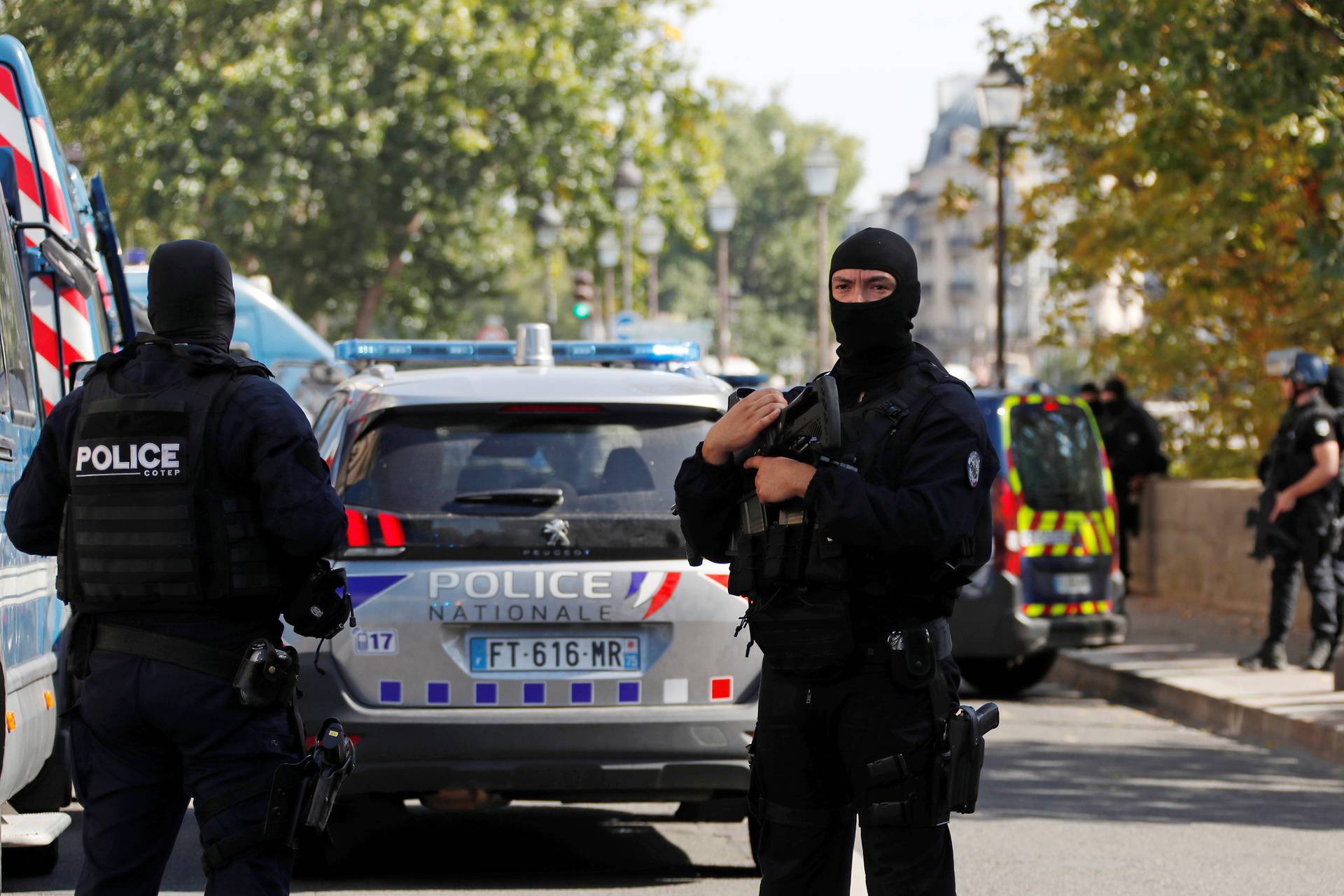 French police forces are seen near the Paris courthouse on the Ile de la Cite in Paris