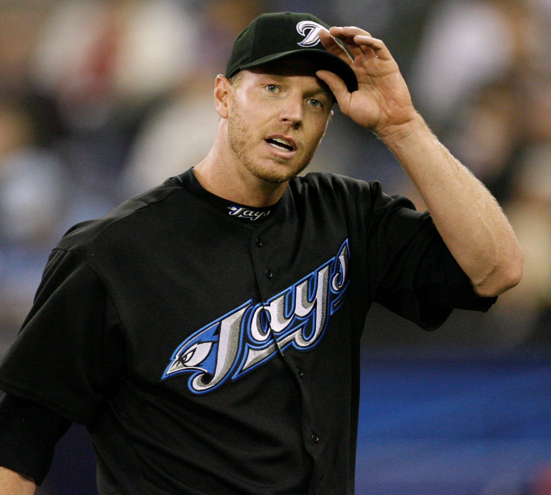 FILE PHOTO: Toronto Blue Jays pitcher Halladay adjusts his cap against the Chicago White Sox in Toronto