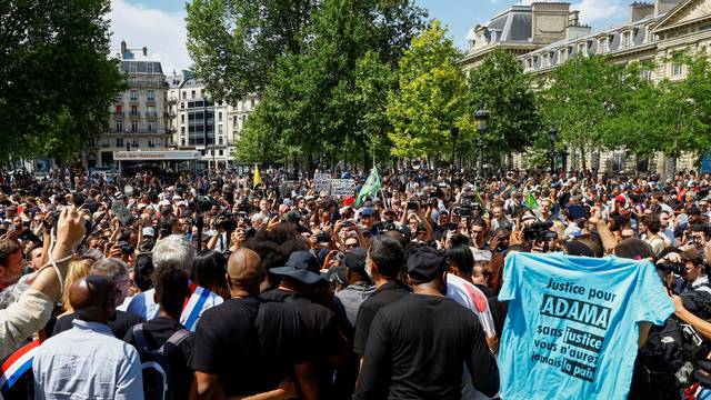 People attend a march in memory of Adama Traore in Paris