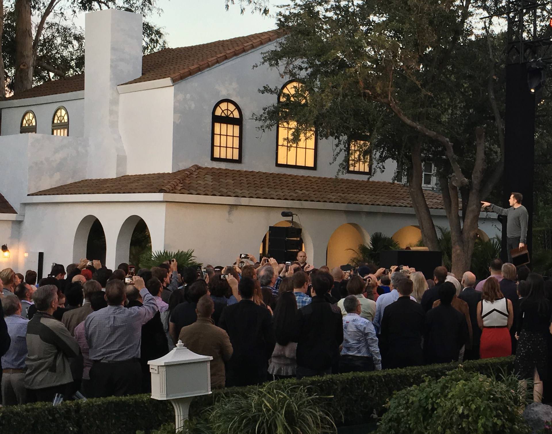 Tesla's electric car, Powerwall and solar roof are shown at an unveiling of new energy products aimed at illustrating the benefits of combining his electric car and battery maker with solar installer SolarCity Corp, in Los Angeles