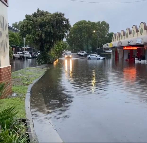 A car drives through a flooded street in Byron Bay, New South Wales