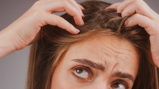 Stressed woman is very upset because of hair loss. Haircut and straightening hair care. Serious hair loss problem for health care shampoo.
