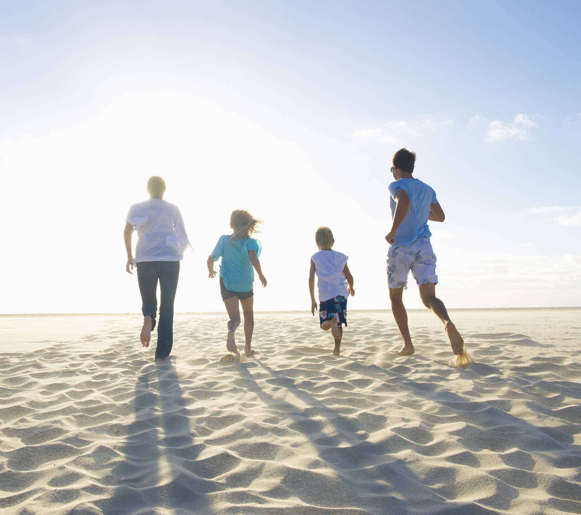 Family running together on beach