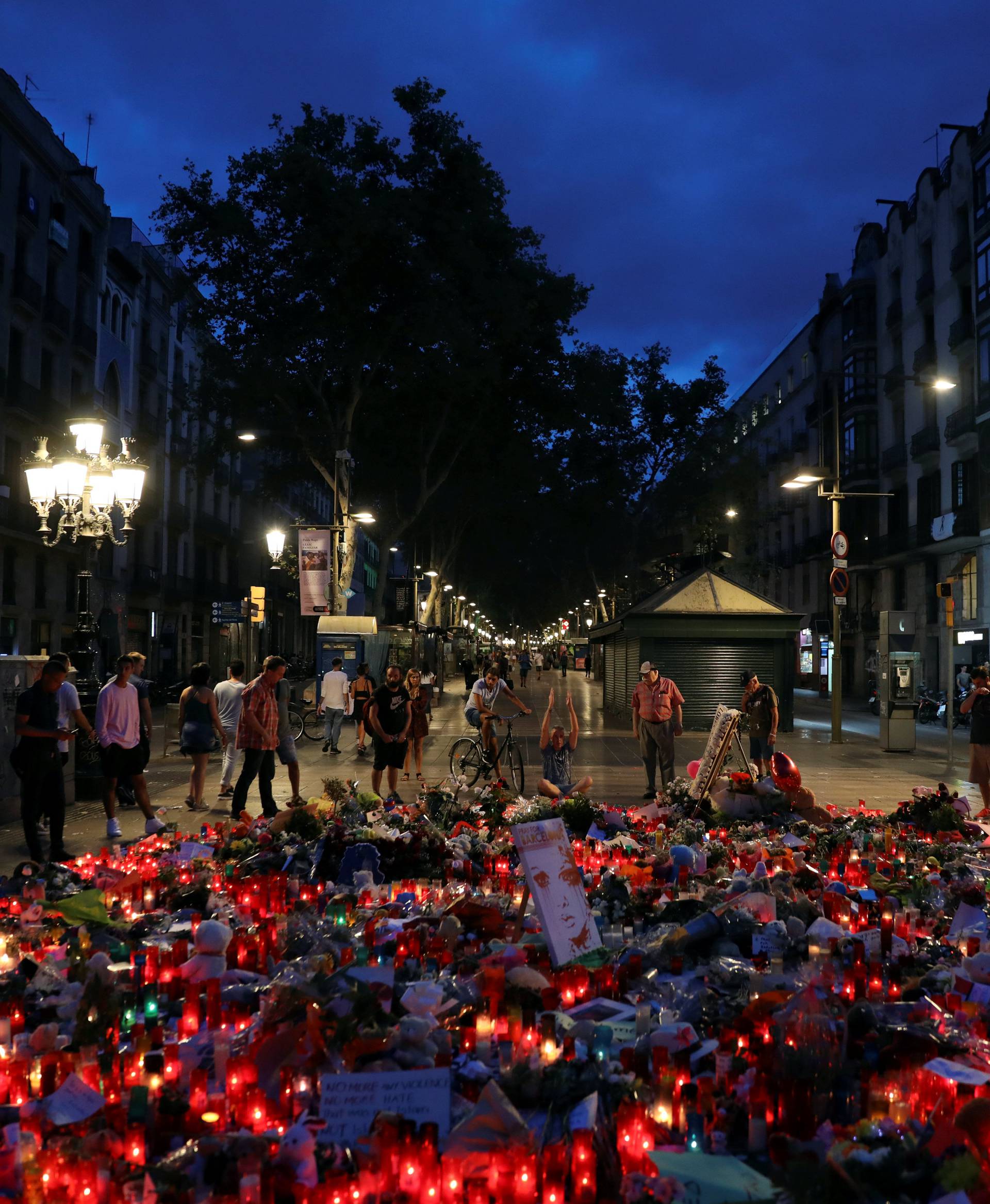 People gather at an impromptu memorial where a van crashed into pedestrians at Las Ramblas in Barcelona