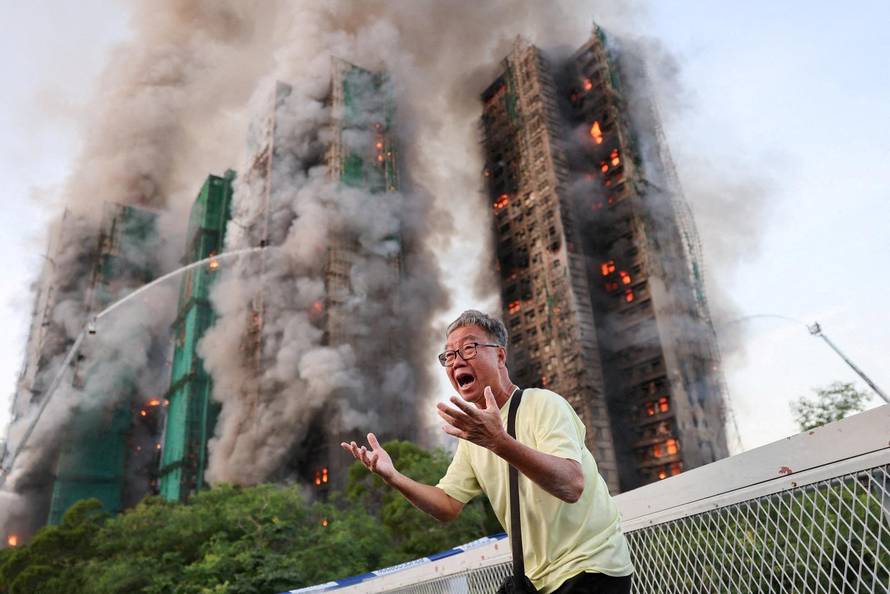 Flames engulf bamboo scaffolding across multiple buildings at Wang Fuk Court housing estate, in Tai Po