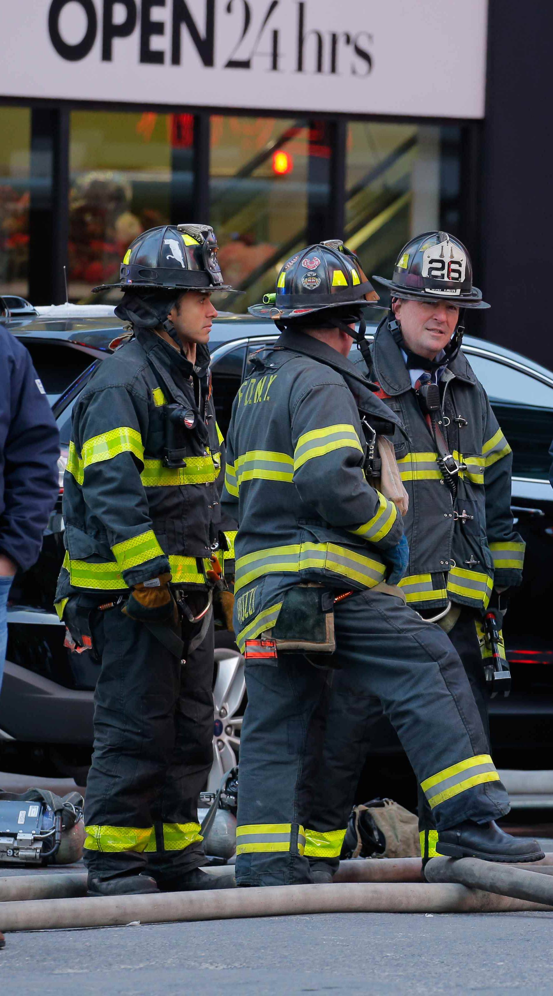 Fire crews stand outside the New York Port Authority Bus Terminal in New York City after reports of an explosion.