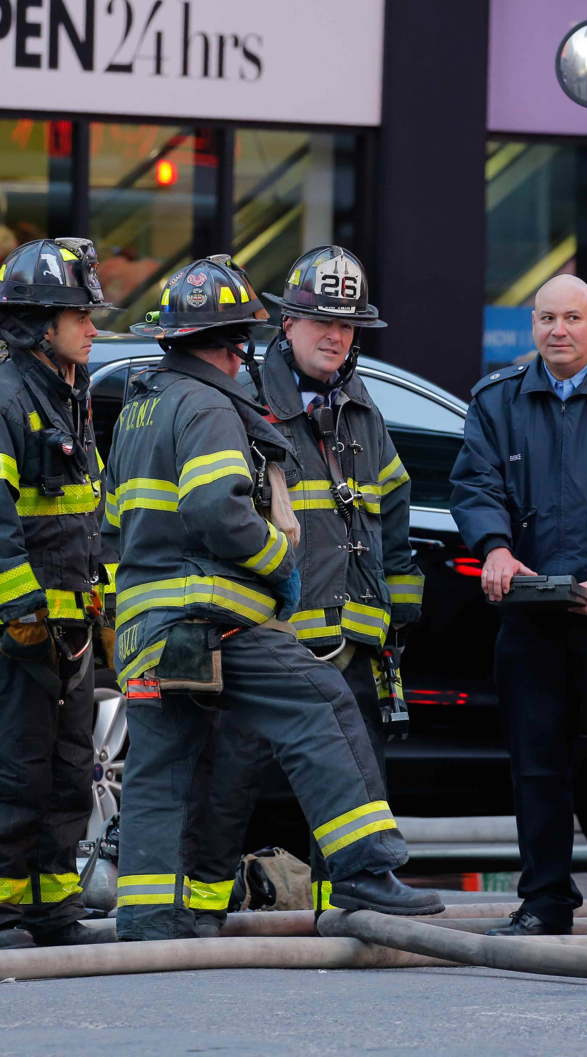 Fire crews stand outside the New York Port Authority Bus Terminal in New York City after reports of an explosion.