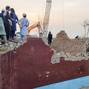 Residents gather on the rubble of a damaged police post after a car bombing in Bannu