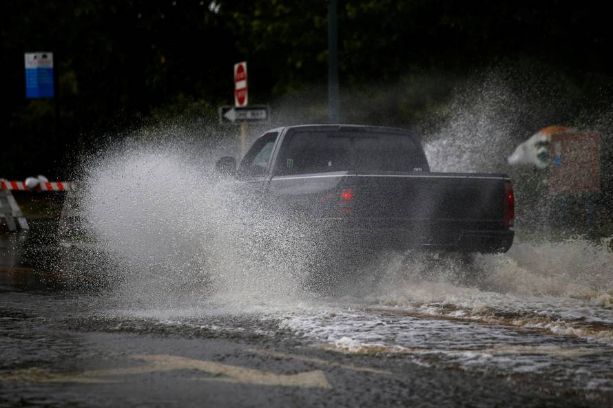 A man drives his vehicle around the Union Point Park Complex through floodwaters as the Hurricane Florence comes ashore in New Bern, North Carolina
