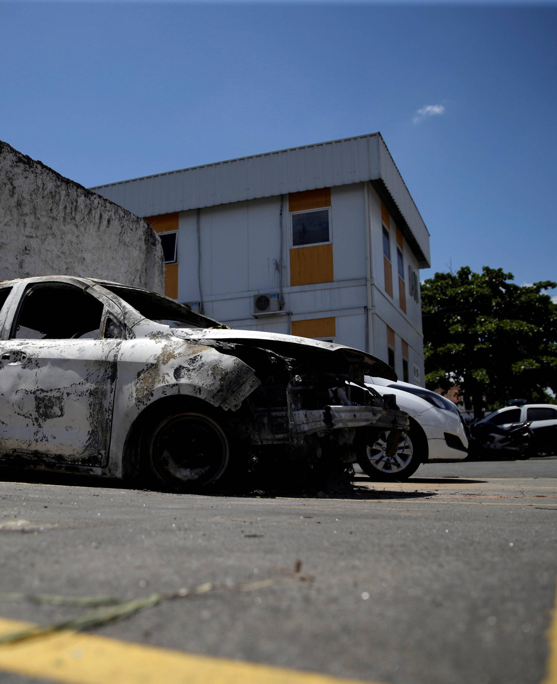 A burnt car in which a body was found during searches for the Greek Ambassador for Brazil Kyriakos Amiridis, is pictured at a police station in Belford Roxo