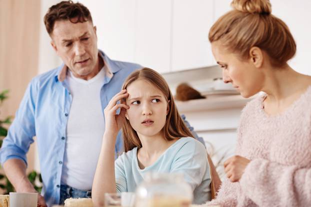 Cheerless,Moody,Girl,Discussing,Problems,With,Her,Parents