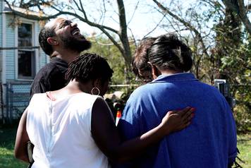 Pastor Oscar Dean prays with others near the site of the shooting at the First Baptist Church of Sutherland