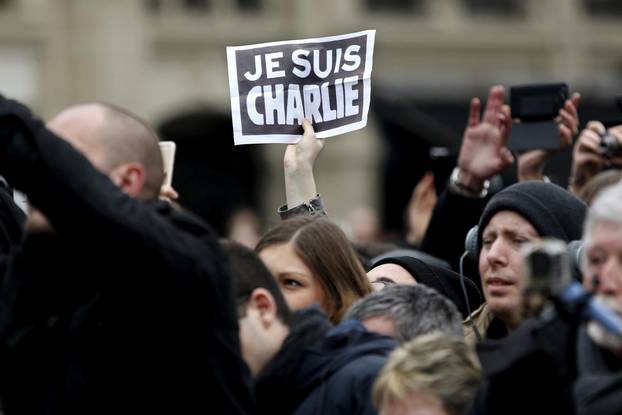 FILE PHOTO: Person holds up a sign during a ceremony at Place de la Republique square to pay tribute to the victims of last year