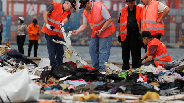 Personnel from National Transportation Safety Board examine debris from Lion Air flight JT610 at Tanjung Priok port in Jakarta