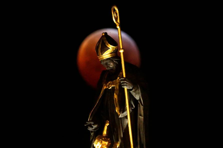 The "Super Blood Wolf Moon" is seen during a lunar eclipse on Brussels' Grand Place
