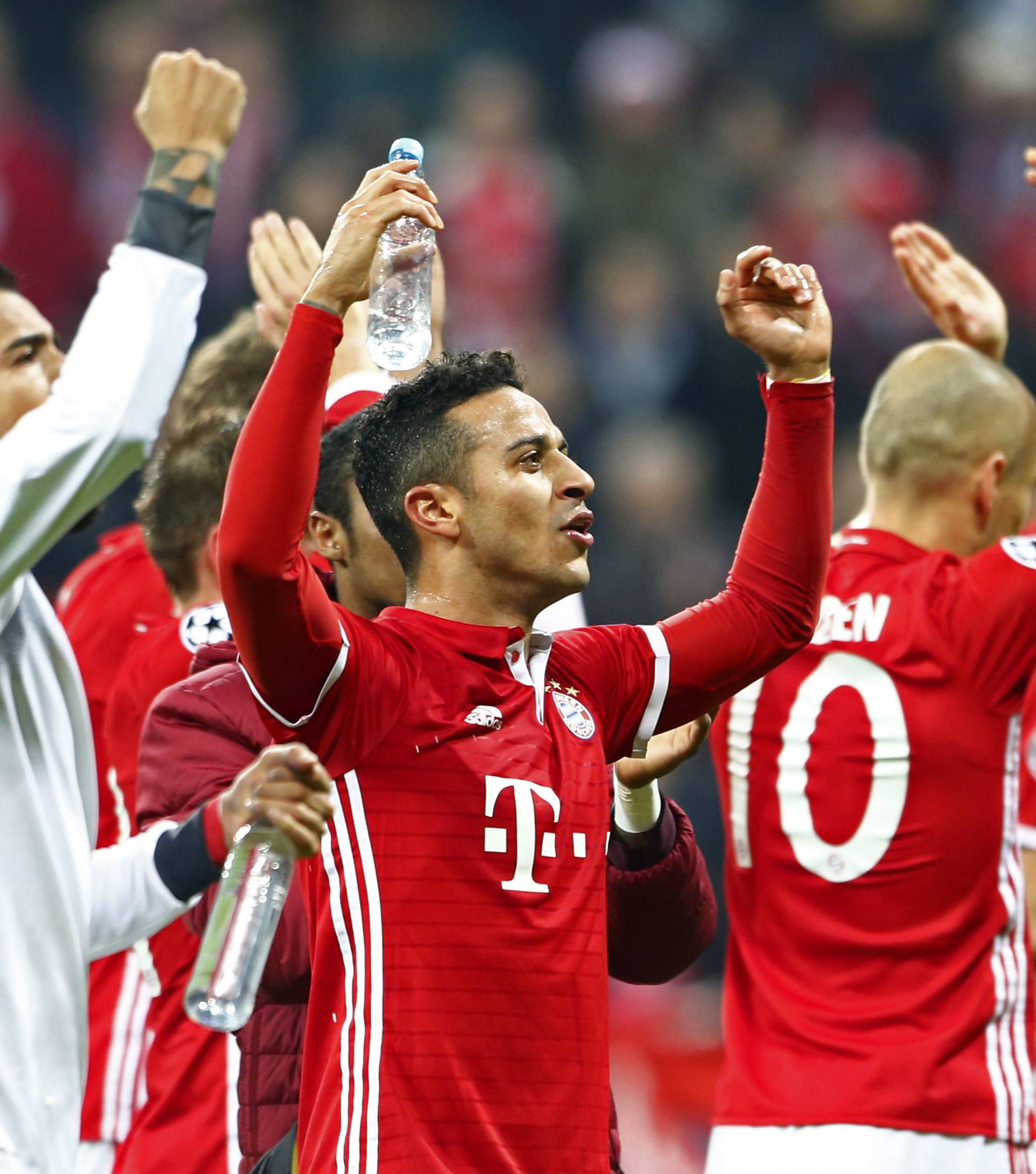 Bayern Munich's Thiago Alcantara celebrates after the game with teammates