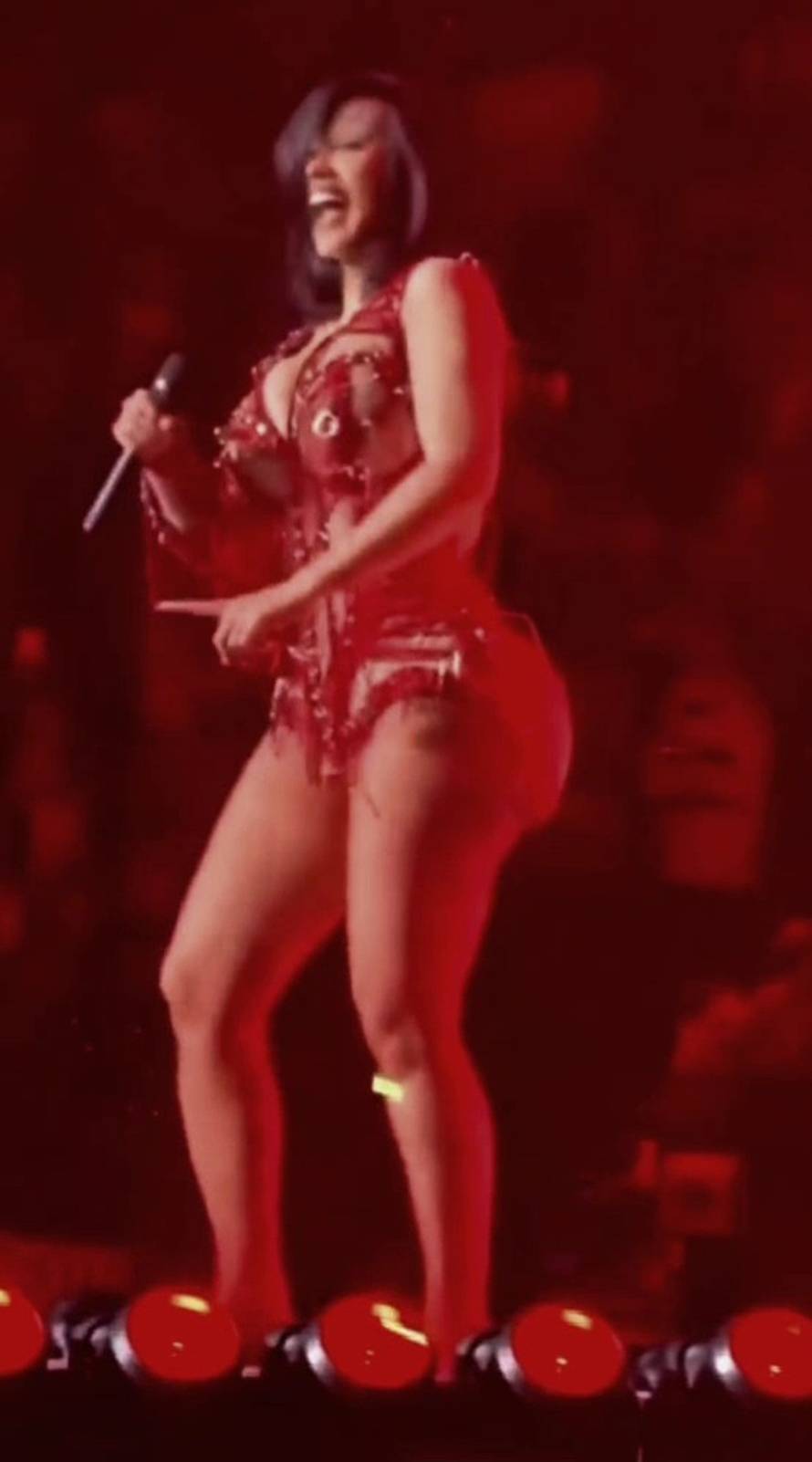 Cardi B laughs as she falls backwards out of a chair during strip dance during  Valentines Day Weekend concert in Las Vegas