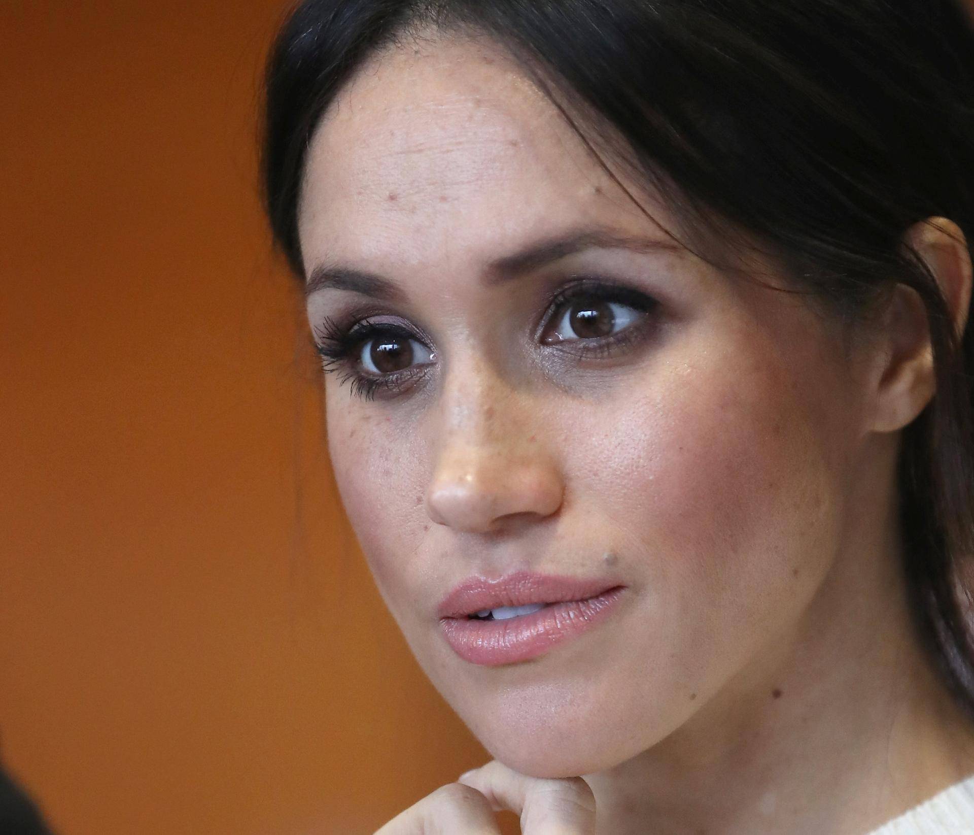 The fiancee of Britain's Prince Harry, Meghan Markle, reacts during a visit to a science park called Catalyst Inc., in Belfast