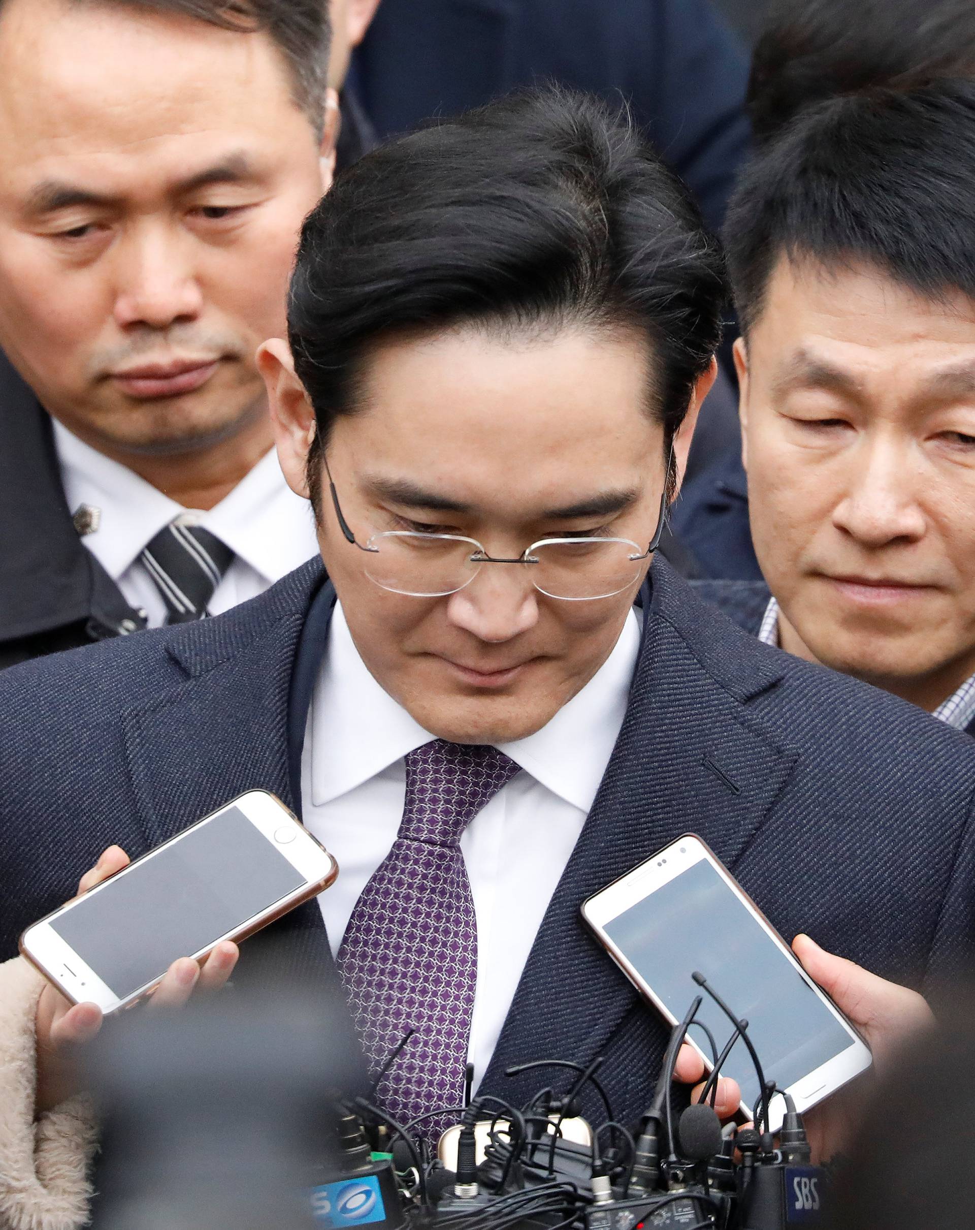 FILE PHOTO - Samsung Group chief, Jay Y. Lee, leaves after attending a court hearing to review a detention warrant request against him at the Seoul Central District Court in Seoul