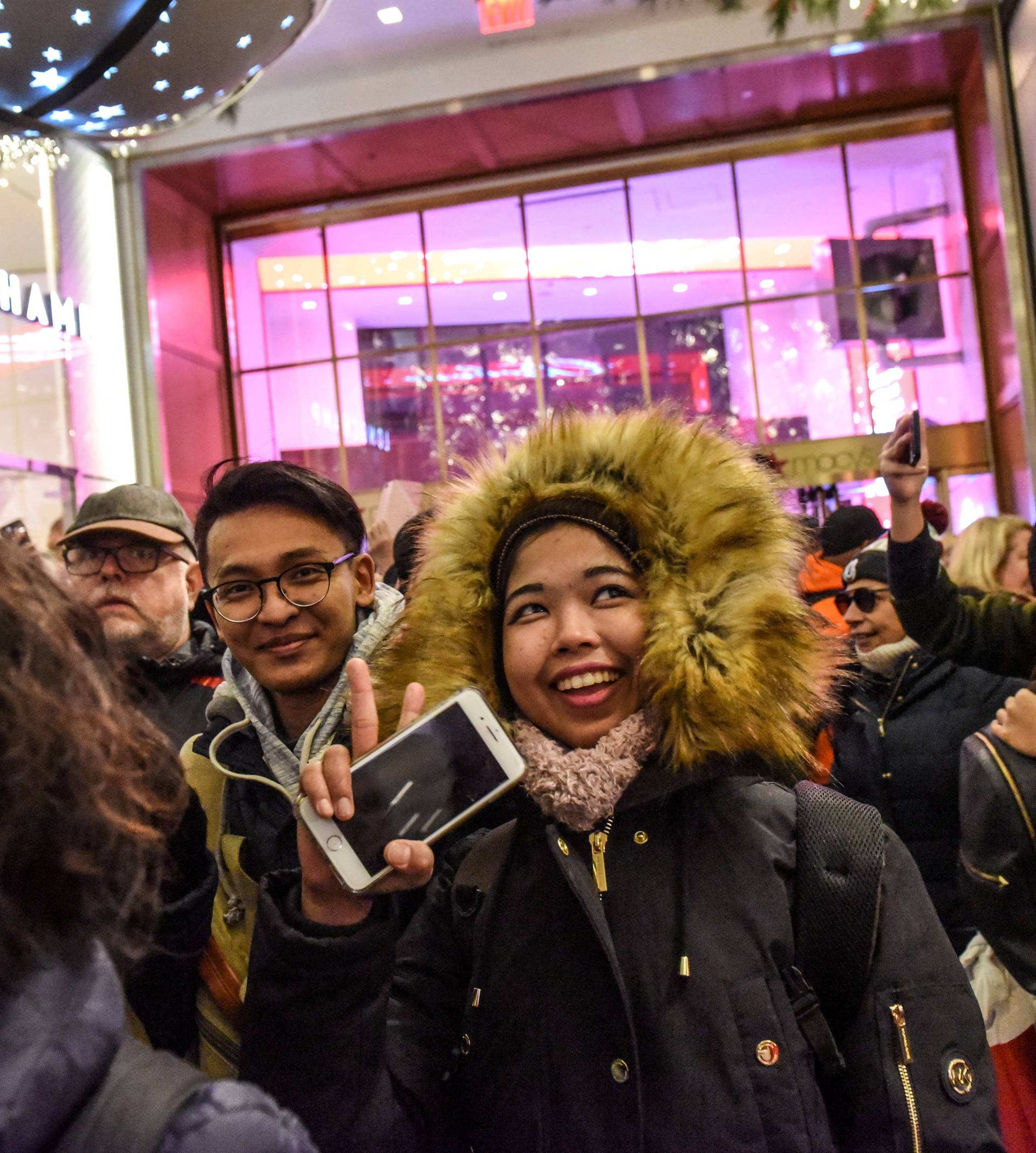 People rush in after the doors are opened during a Black Friday sales event at Macy's flagship store in New York
