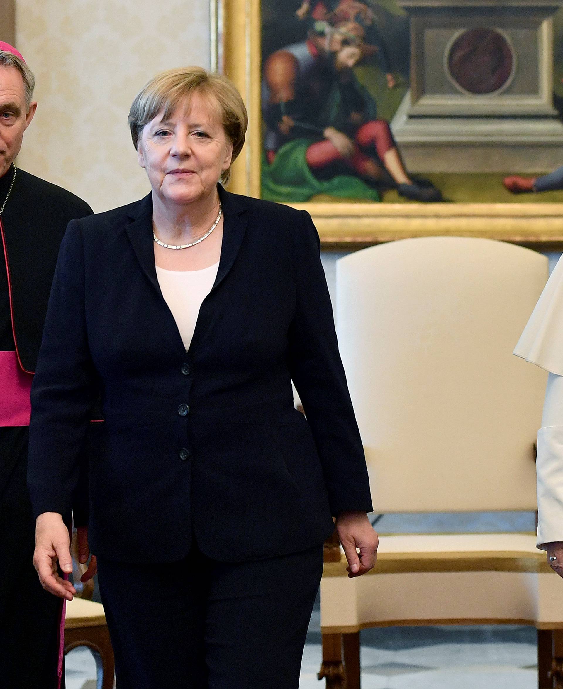 German Chancellor Merkel poses with Pope Francis during a meeting at the Vatican