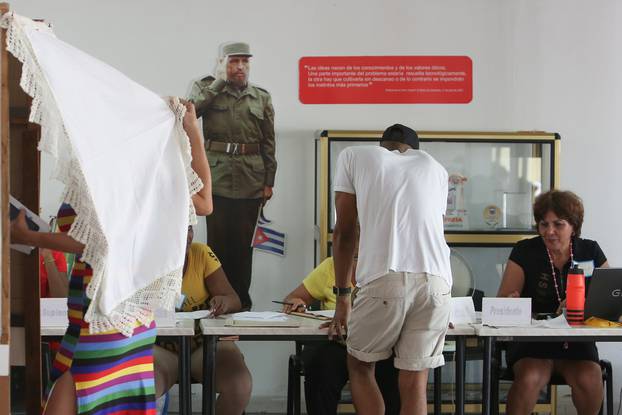 An image of late Cuban President Fidel Castro is displayed at the wall of a polling station during a constitutional referendum in Havana