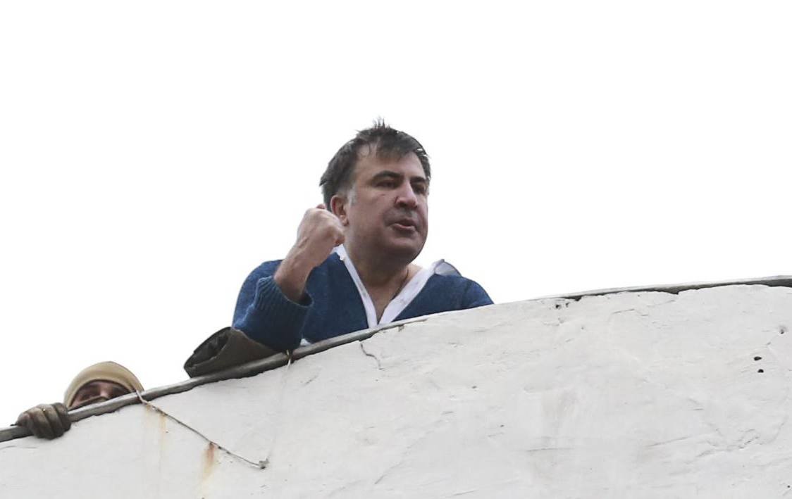 Georgian former President Mikheil Saakashvili is seen on the roof of a building during a search of his apartment in Kiev