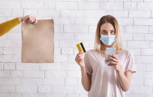 Online shopping during coronavirus quarantine. Female in protective mask