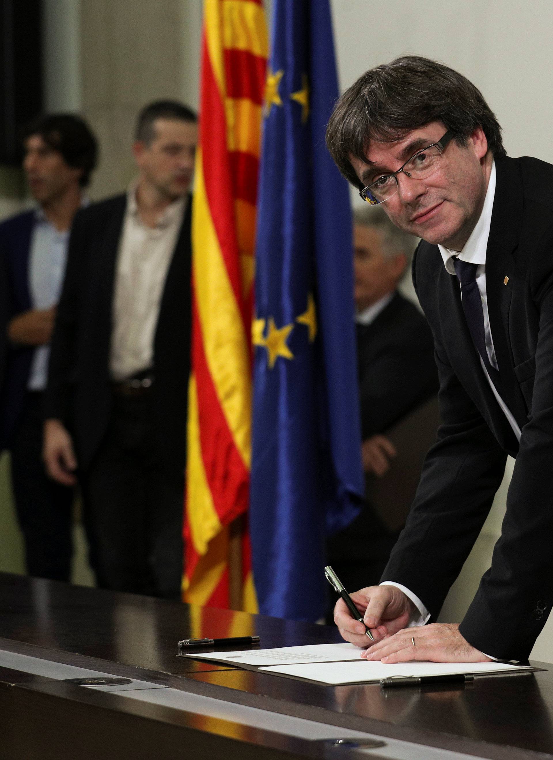 Catalan President Carles Puigdemont signs a declaration of independence Catalan regional parliament in Barcelona