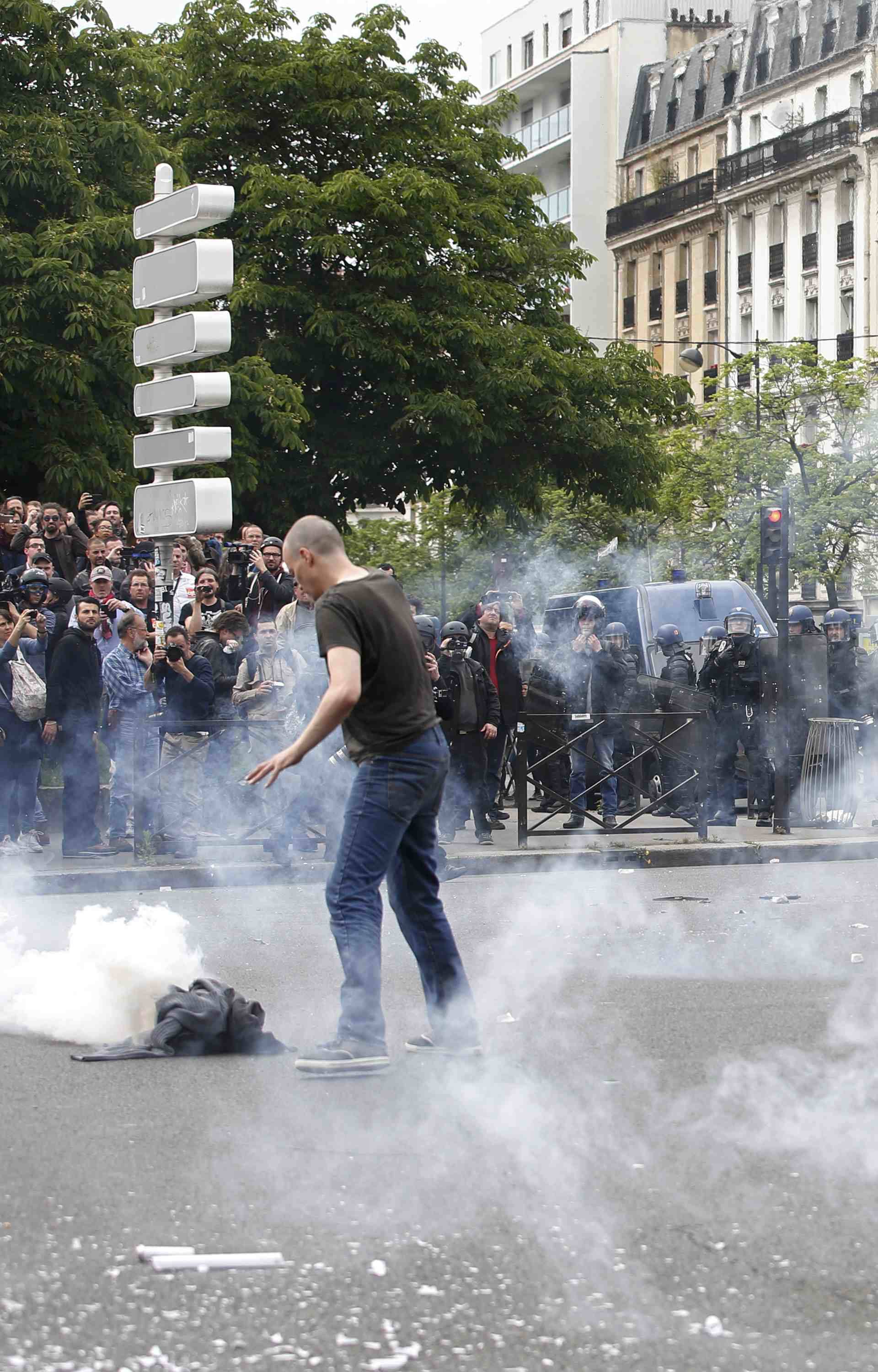  Tear gas fills the air during clashes with French gendarmes during a demonstration in protest of the government's proposed labor law reforms in Paris