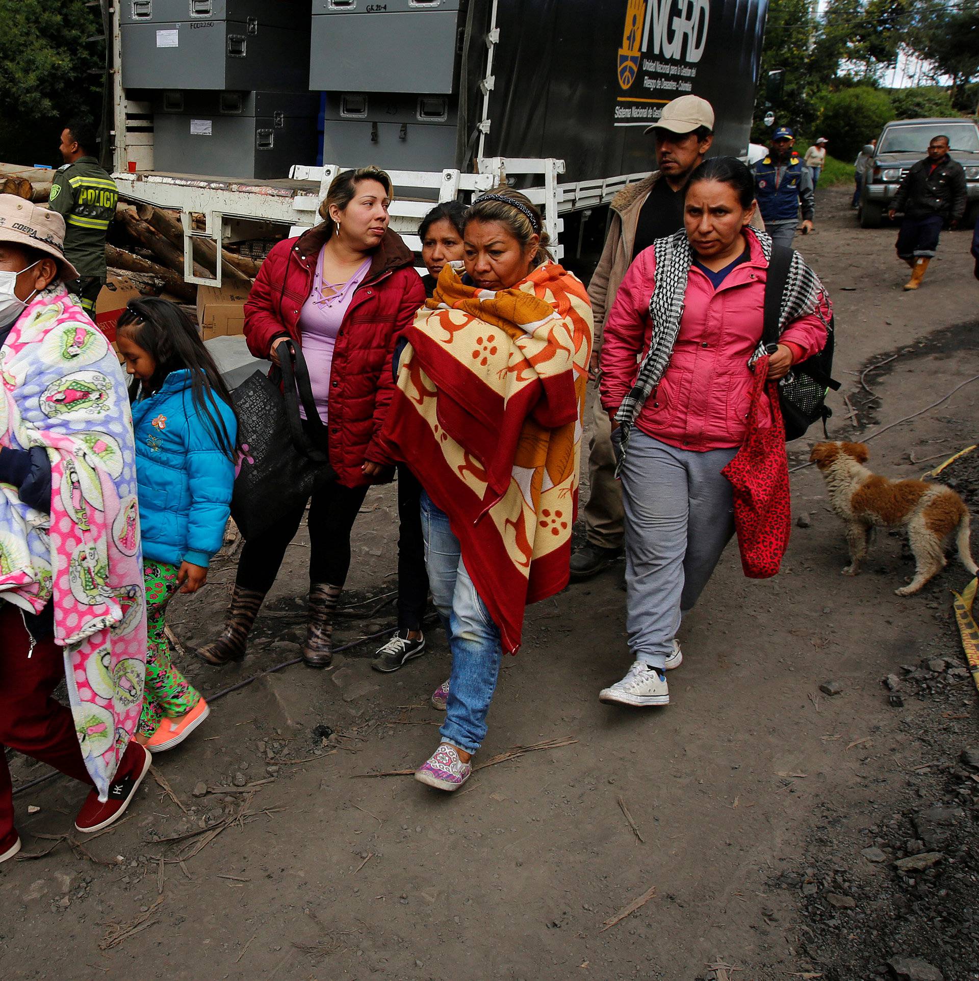 People wait for news of their missing relatives after an explosion at an underground coal mine  on Friday, in Cucunuba