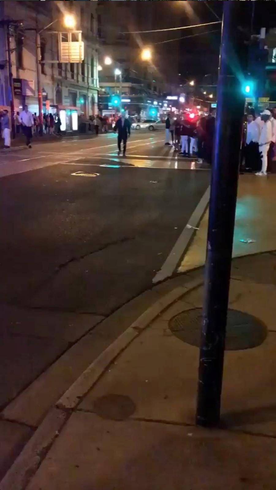 People are seen along a road following a shooting incident outside a nightclub, in Prahran, Melbourne, Australia in this still frame taken from social media video