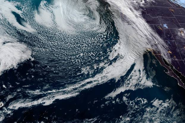 Heavy cloud system moves towards the U.S. west coast in a composite image from the NOAA GOES-West weather satellite