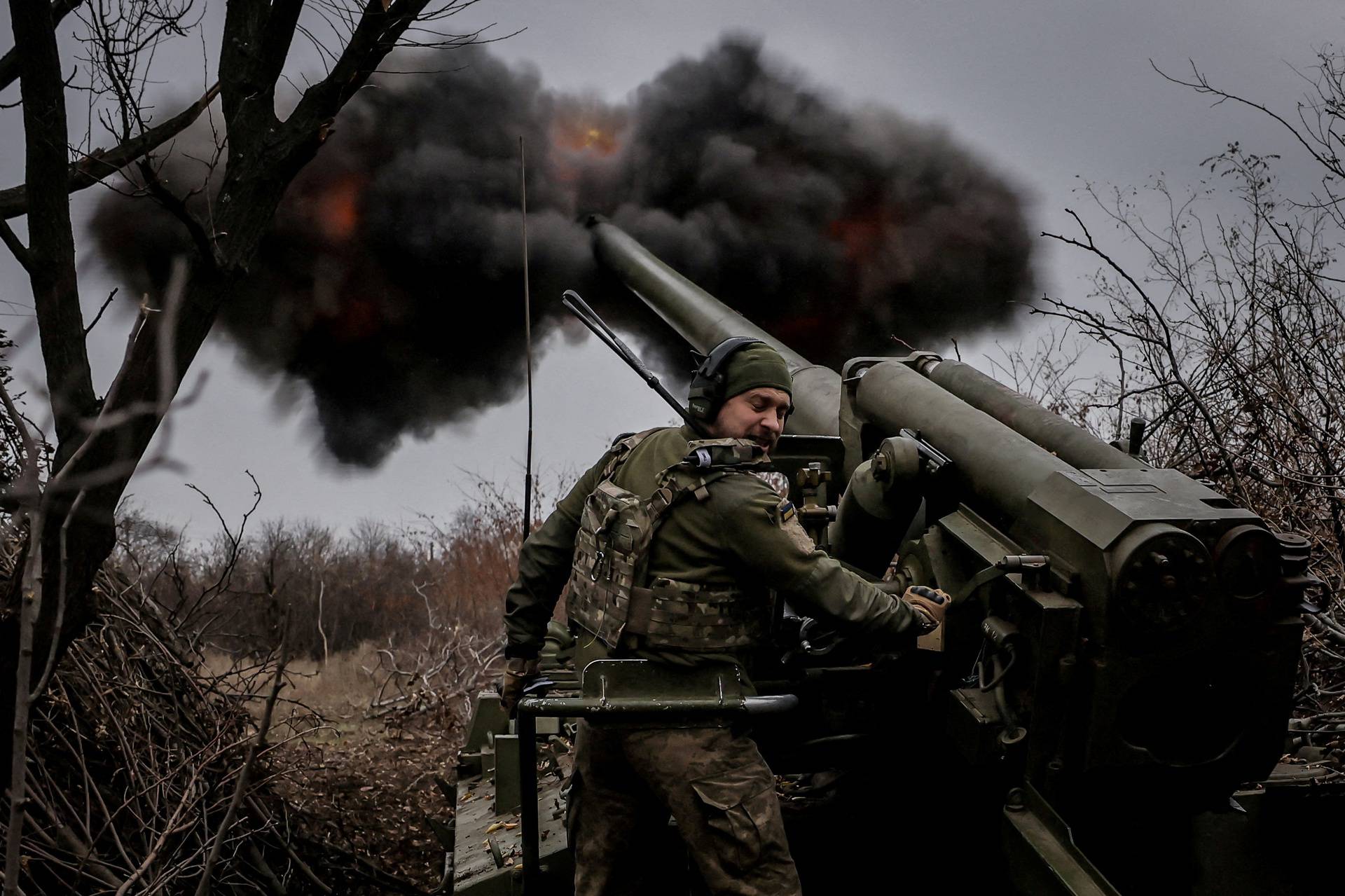 FILE PHOTO: Ukrainian servicemen fire a self-propelled howitzer towards Russian troops at a front line near the town of Chasiv Yar