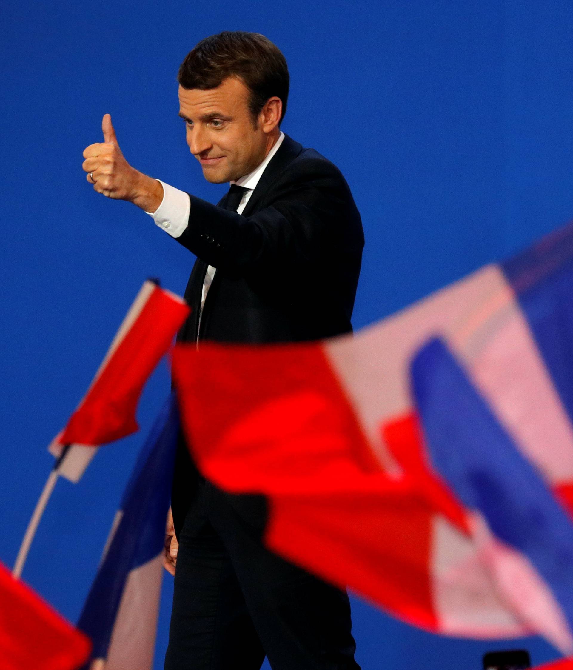 Emmanuel Macron, head of the political movement En Marche !, or Onwards !, and candidate for the 2017 French presidential election, gestures to supporters after the first round of 2017 French presidential election in Paris