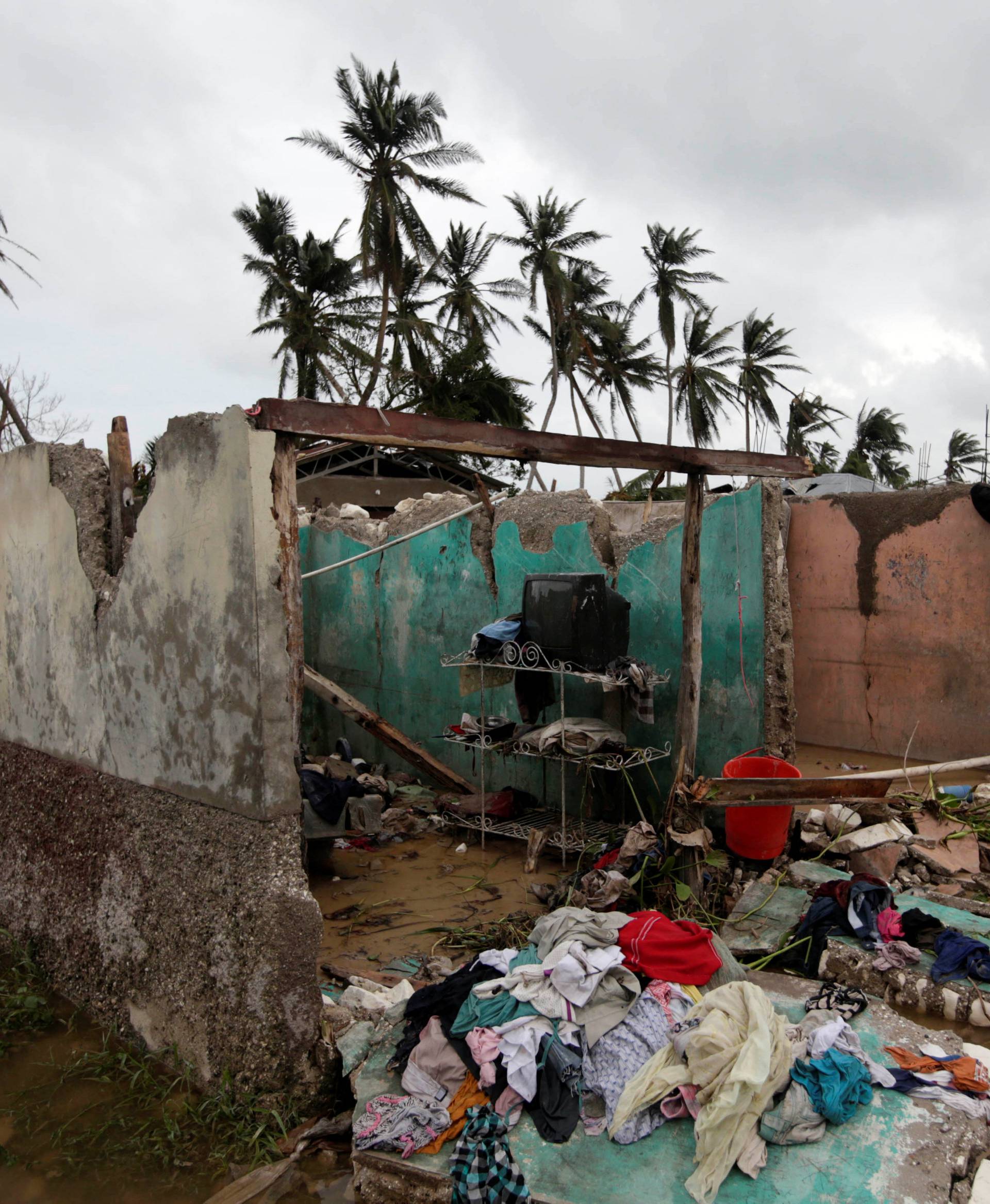 A television is seen in a house destroyed by Hurricane Matthew in Les Cayes